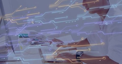 Male professional working at desk with smartwatch and futuristic circuit data overlay