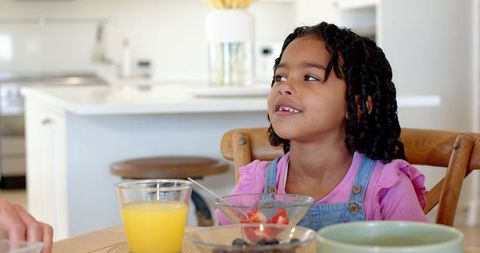 Young Girl Enjoying Healthy Breakfast in Modern Kitchen Ambiance