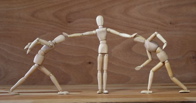 Wooden Mannequins Representing Conflict and Resolution on Wooden Background - Download Free Stock Images Pikwizard.com