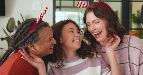 Happy family celebrating with festive candy cane headbands