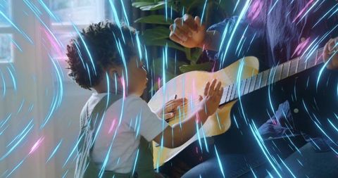 Mother and Son Bonding with Acoustic Guitar and Vibrant Neon Sparkles