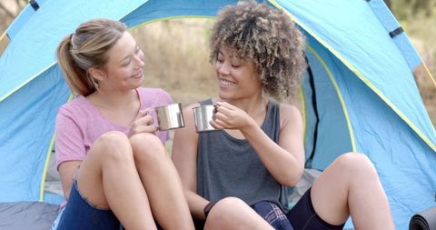 Smiling Friends Enjoying Outdoor Camping Together