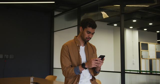 Young Professional Using Smartphone in Modern Office - Download Free Stock Images Pikwizard.com