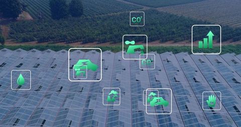 Aerial greenhouse roofs with smart agriculture icons tracking sustainability and crop health