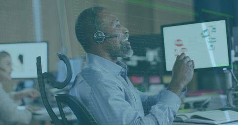 African American Senior Using Headset in Modern Office