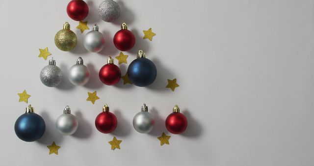 Festive Christmas arrangement featuring colorful baubles and golden stars forming a tree shape against a clean white background. Ideal for holiday greeting cards, seasonal promotions, party invitations, and festive DIY craft projects.