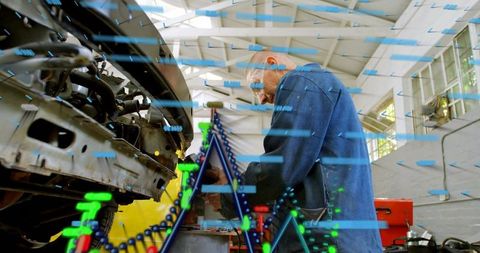 Mechanic repairing car engine with augmented reality diagnostics overlay in workshop