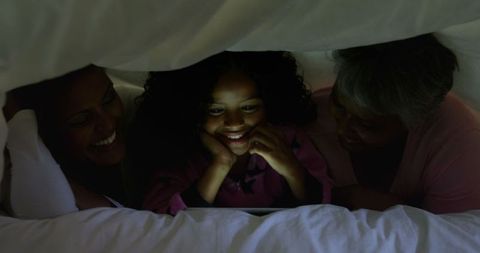 Family Bonding Under Blanket Watching Tablet
