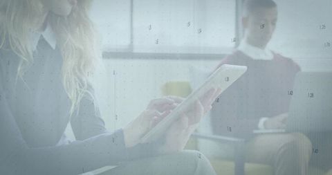 Professionals Engaging with Technology in Modern Office Lounge