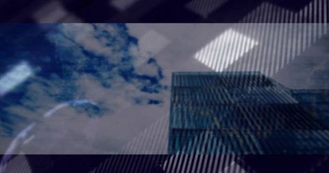 Reflective Glass Skyscraper Against Cloudy Sky in Urban Landscape