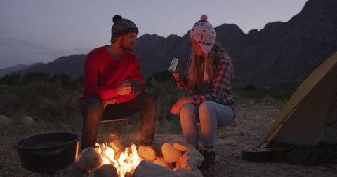 Couple Enjoying Campfire in Scenic Mountain Setting - Download Free Stock Images Pikwizard.com