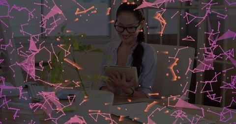 Asian Businesswoman Engaged with Tablet in Modern Office Environment