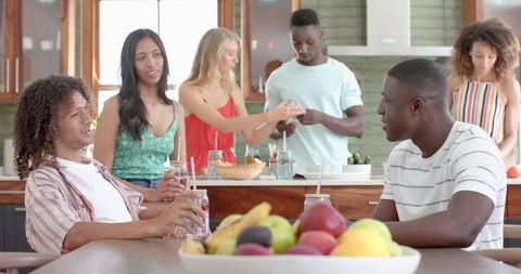 Diverse Friends Socializing in Kitchen with Food Preparation