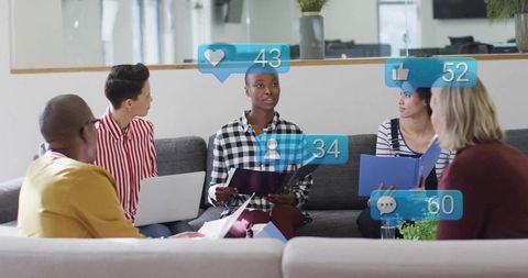 Black Woman Presenting to Diverse Team in Modern Office Lounge with Social Reactions