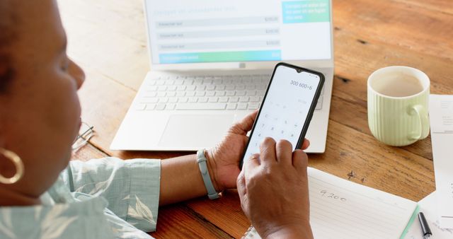 Woman Calculating Finances on Smartphone with Notebook and Laptop - Download Free Stock Images Pikwizard.com