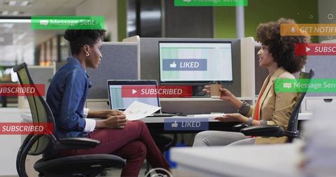 Colleagues discussing marketing analytics in modern open office with floating notifications