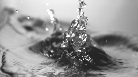 Ice Cube Splashing in Water Slow Motion Close-Up