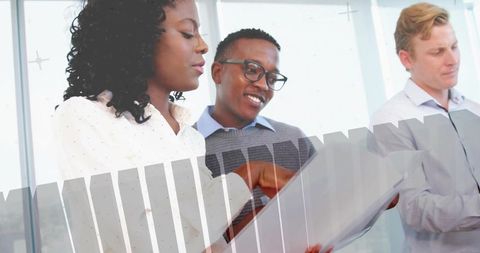 Group of office professionals analyzing business documents during team meeting