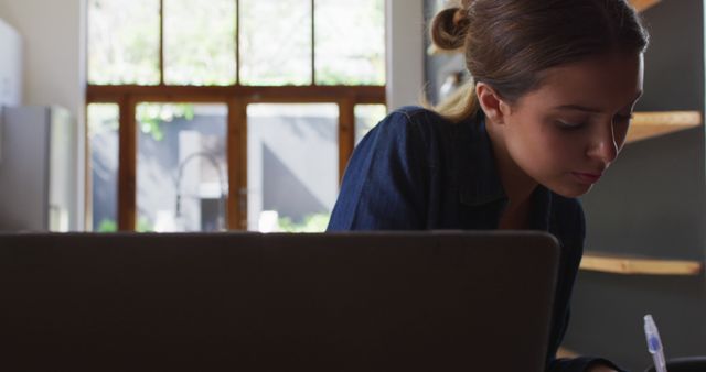 Focused Woman Working in Sunlit Home Office - Download Free Stock Images Pikwizard.com