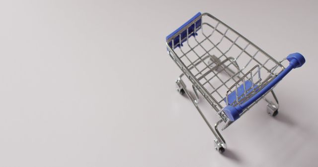 High angle view of empty shopping trolley on white background with copy space. Shopping, sale and retail concept digitally generated image.