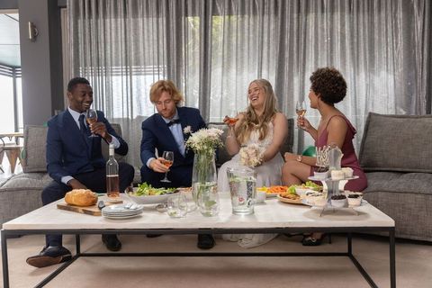 Wedding party enjoying appetizers with wine in elegant lounge