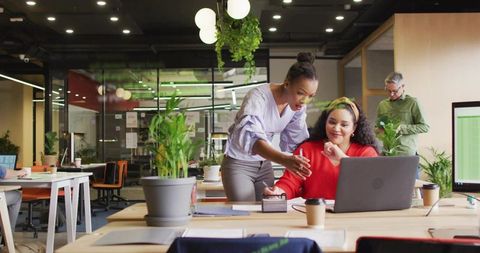 Two Women Collaborating in Modern Office Workspace