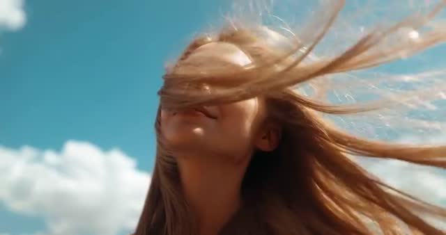 Woman Enjoying Breeze Outdoors under Clear Blue Sky