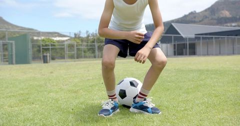 Young Child Practicing Ball Control on Soccer Field