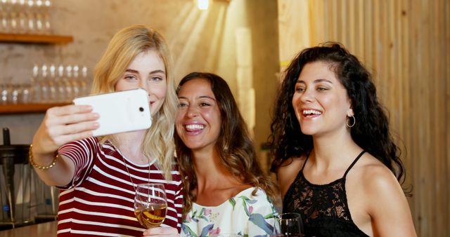 Smiling Friends Taking Selfie in Cozy Bar Setting - Download Free Stock Images Pikwizard.com