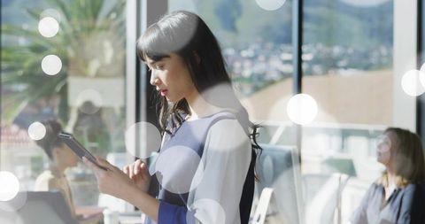 Businesswoman Using Tablet in Modern Office with City View