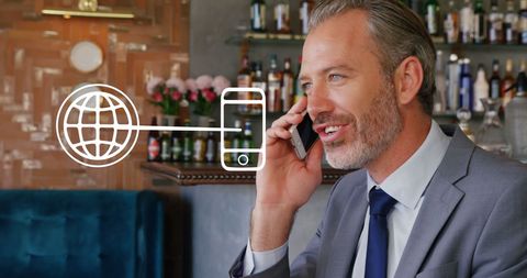 Businessman using smartphone with digital global icons