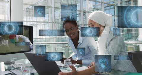 Businesswomen Analyzing Financial Data on Laptop with Holographic Projections