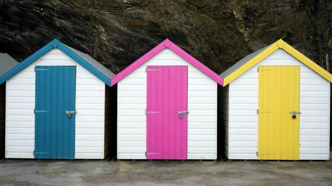 Colorful Beach Huts with Vibrant Doors at Coastline
