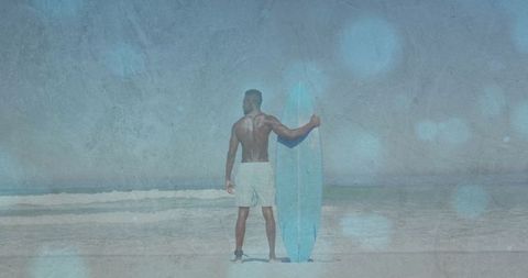 Surfer Holding Surfboard on Tranquil Beach Preparing for Adventure