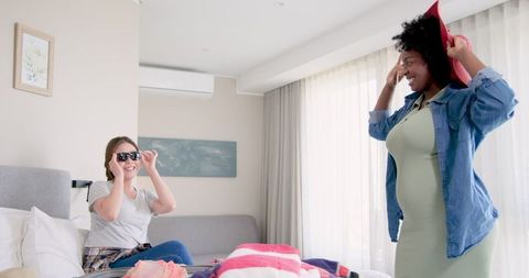 Joyful Friends Preparing for Vacation at Home