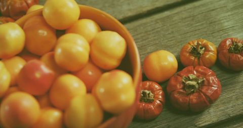 Eco-Friendly Harvest of Yellow and Red Tomatoes on Wooden Surface