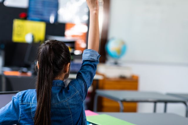 Biracial Girl Raising Hand in Elementary School Classroom - Download Free Stock Images Pikwizard.com