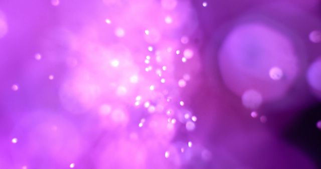 A vibrant purple abstract bokeh background, with copy space. Ideal for festive or creative concepts, the image exudes a dreamy and celebratory mood.
