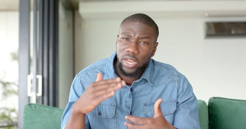 Man Engaging in Gestures While Speaking at Home