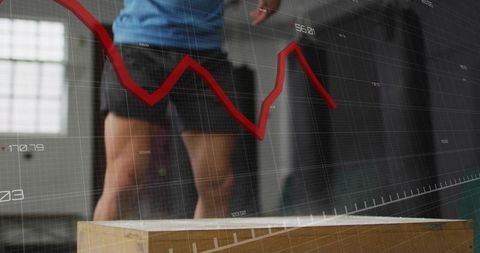 Male athlete preparing for box jump with red performance graph overlay, fitness analytics