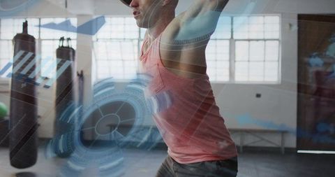 Futuristic boxing training with hud overlay featuring athletic man hitting punching bag