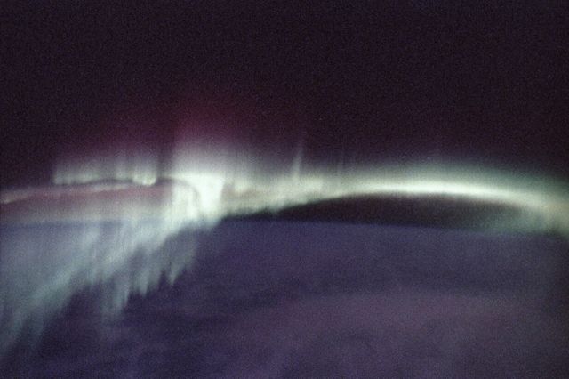This photograph of aurora borealis, northern aurora, was taken during the Spacelab-J (SL-J) mission (STS-47). People who live in the northernmost areas like Alaska or work in the southernmost regions like Antarctica often see colorful lights produced by Earth's natural electromagnetic generator; these shimmering expanses of light are auroras, commonly called the northern and southern lights. Charged particles from the magnetosphere follow magnetic fields and are accelerated toward Earth at the magnetic poles where they strike molecules in the upper atmosphere, staining the sky with the red and green lights of oxygen and hydrogen, and the purples and pinks of nitrogen. The altitude and inclination of the Spacelab will give scientists unique views of auroras, which occur at altitudes ranging from about 90 to 300 kilometers (56 to 186 miles). Most views of the auroras have been from the ground where only limited parts can be seen. These Skylab views will give scientists information on their complex structure and chemical composition. The Spacelab-J was a joint mission of NASA and the National Space Development Agency of Japan (NASDA) utilizing a marned Spacelab module. The mission conducted microgravity investigations in materials and life sciences. The SL-J was launched aboard the Space Shuttle Orbiter Endeavour (STS-47) on September 12, 1992.