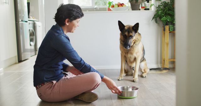 Caucasian woman feeding her dog in the living room at home. pet love and care concept