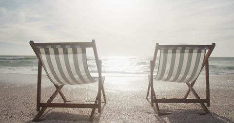 relaxing beachfront escape with sunny deck chairs by ocean - Download Free Stock Images Pikwizard.com