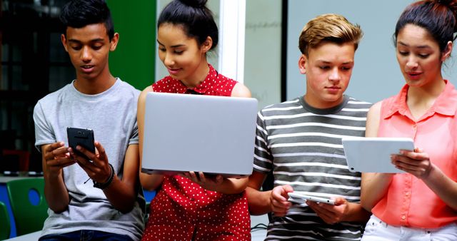 Teenagers Engaging with Various Digital Devices in Modern Classroom - Download Free Stock Images Pikwizard.com