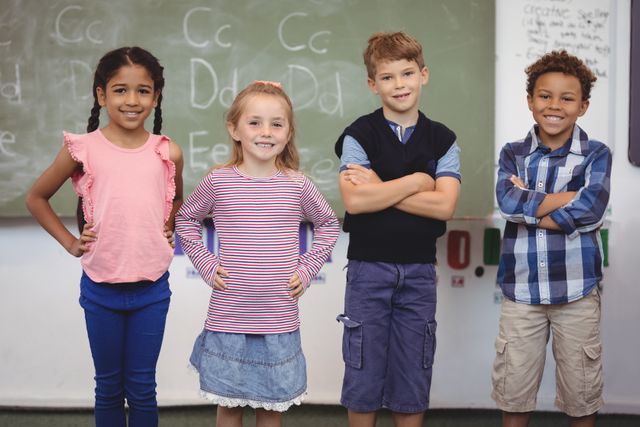 Group of diverse schoolchildren standing in classroom, smiling confidently. Ideal for educational materials, school advertisements, and articles on childhood education and diversity.