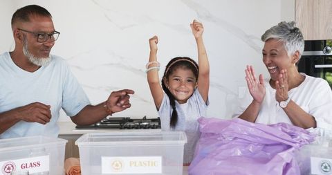 Joyful Family Teaching Recycling to Young Girl at Home