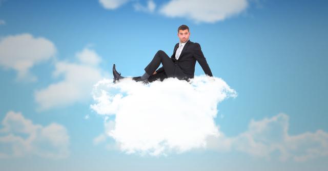 Businessman sitting on a fluffy cloud against a blue sky, depicting imagination and creativity. This surreal image is perfect for illustrating concepts related to innovation, creative thinking, flexibility in business, or the idea of cloud-based technology solutions. Ideal for use in advertisements, presentations, blogs, or digital content focusing on visionary strategies or technology services.