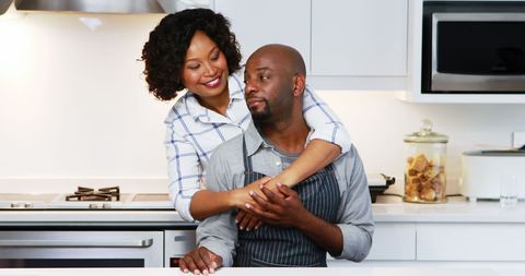 African American Couple Embracing in Modern Kitchen - Download Free Stock Images Pikwizard.com