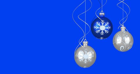 Festive Christmas Baubles with Snowflake Design on Blue Background